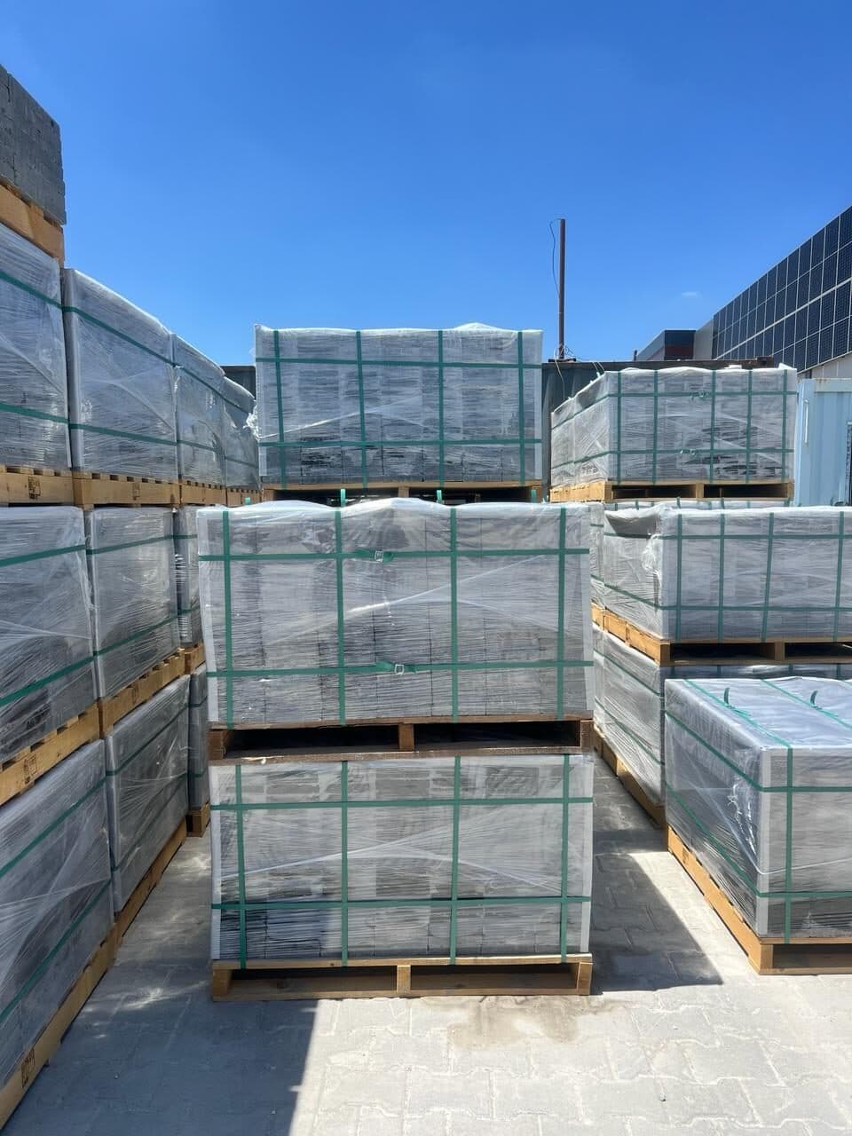 Strapped and shrink-wrapped stone pallets ready for export loading