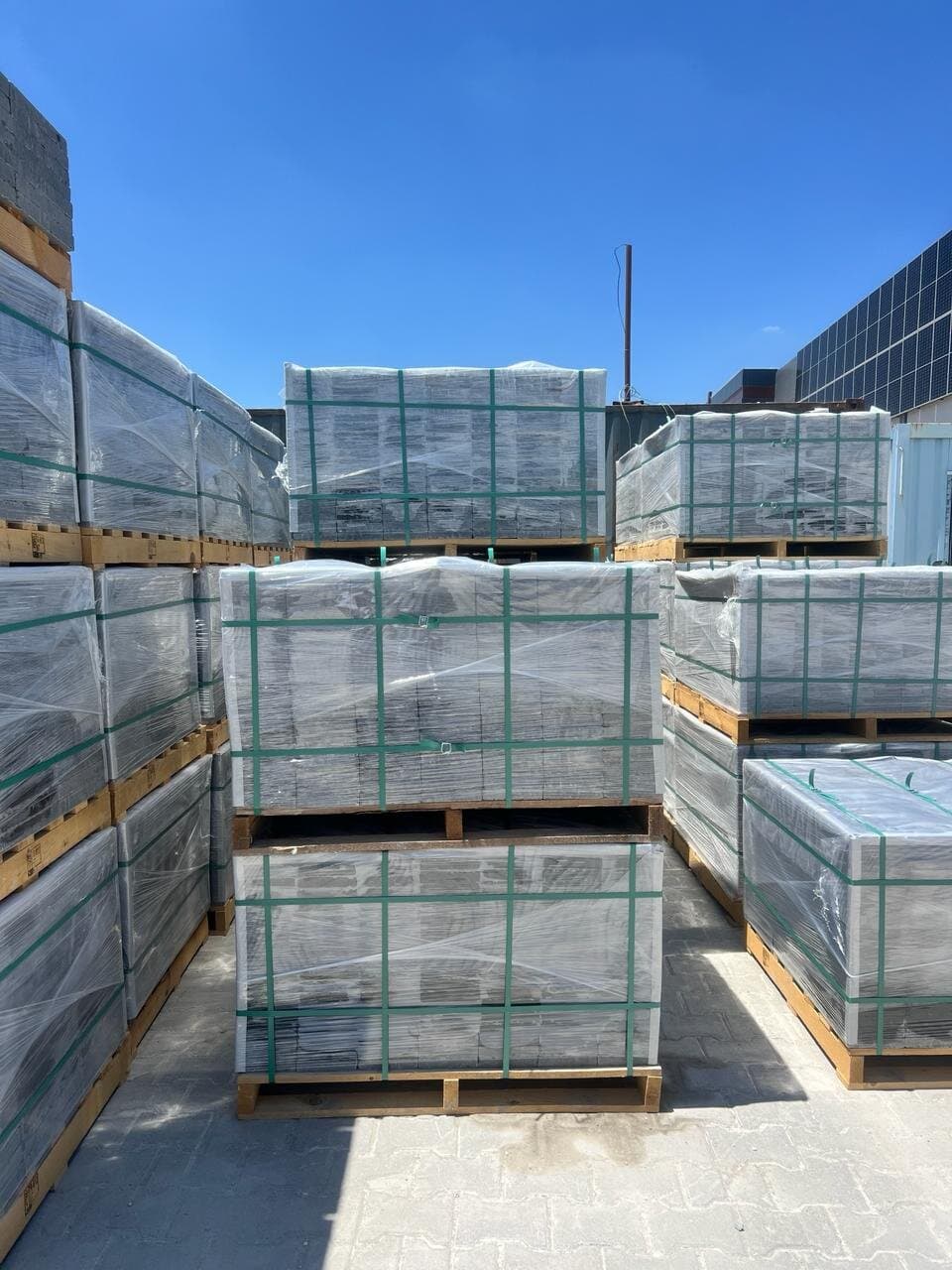 Shrink-wrapped, strapped basalt export pallets staged in the yard, ready for container loading